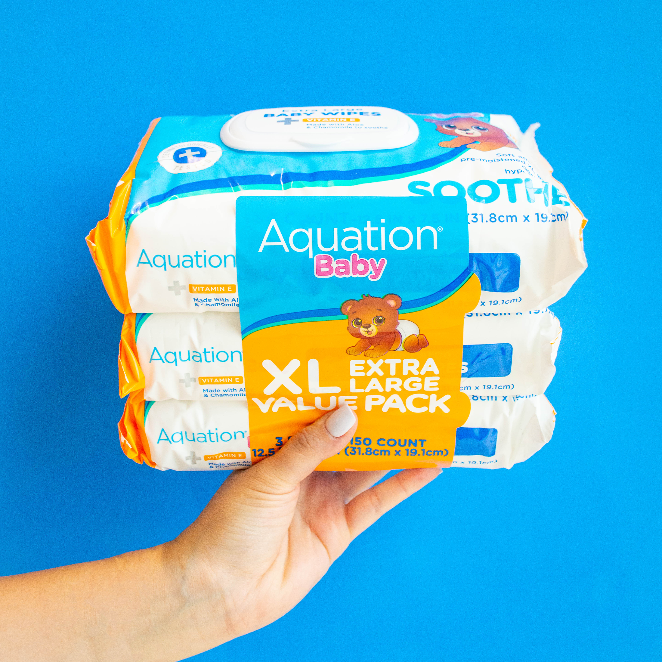 Hand holding Aquation Baby Soothe XL Wipes Value Pack
